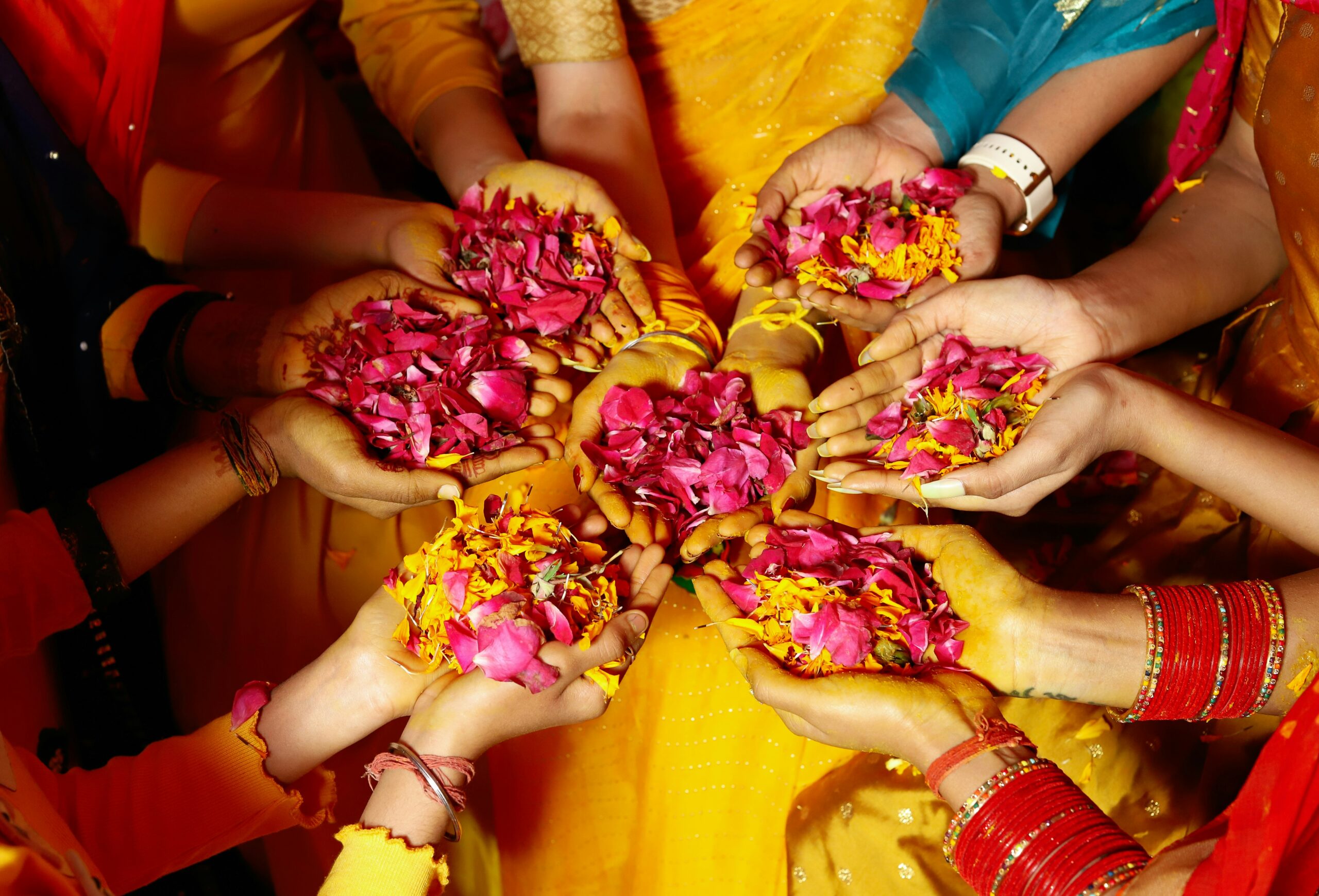 Image of women holding petals in a circle
